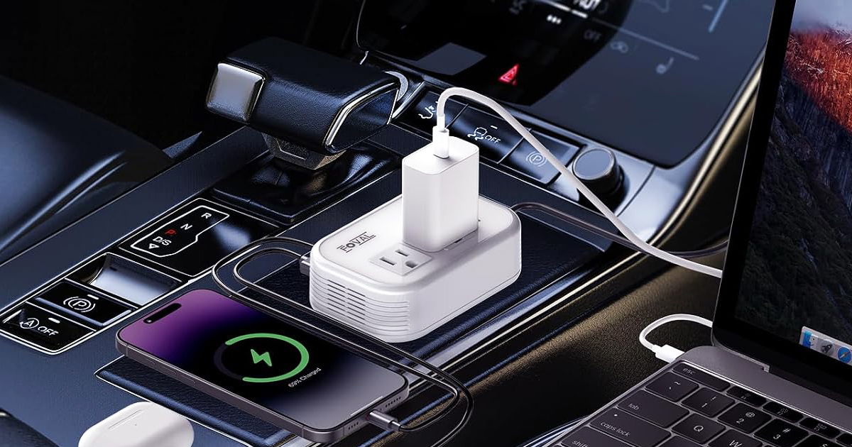 Car power inverter charging multiple devices including a smartphone and laptop inside a vehicle