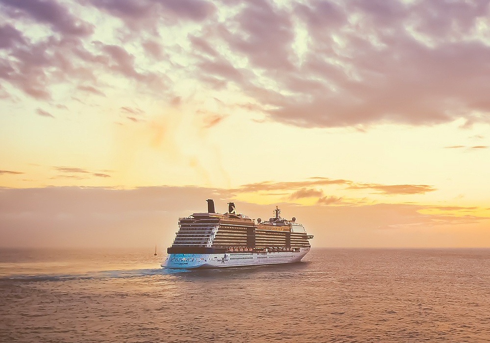 Cruise ship sailing in sunset