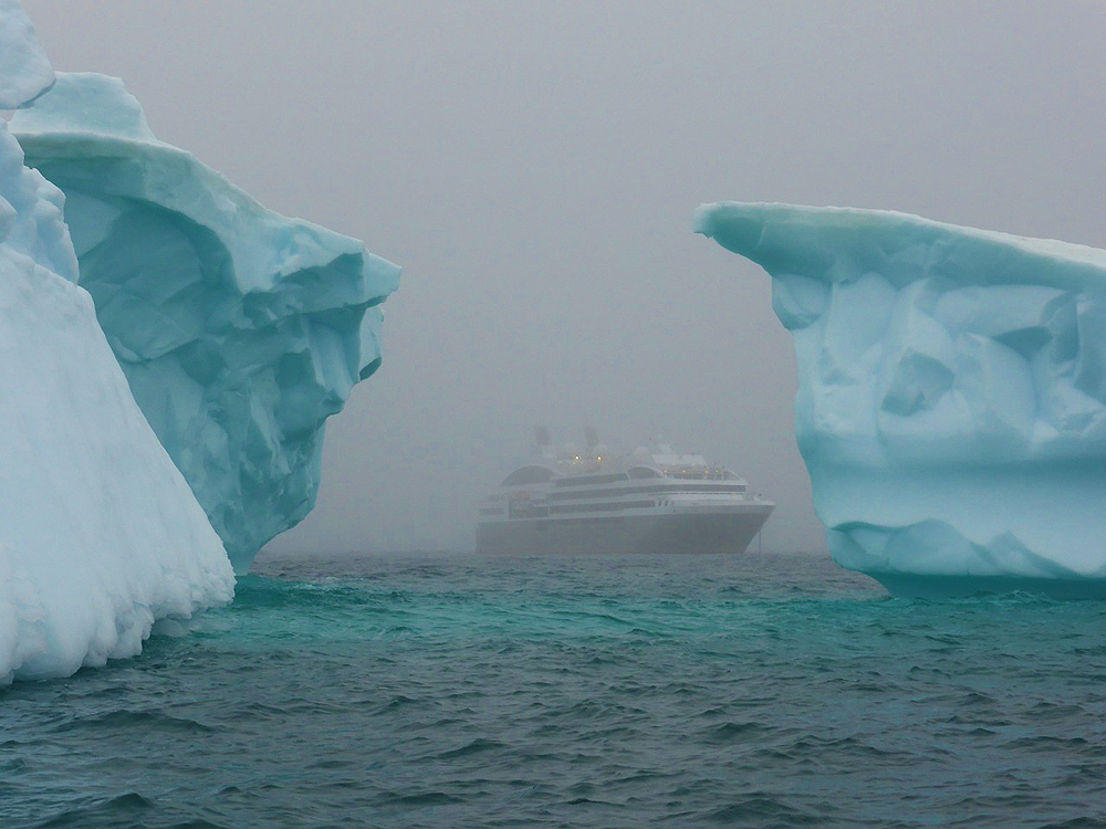 cruise ship between iceberg