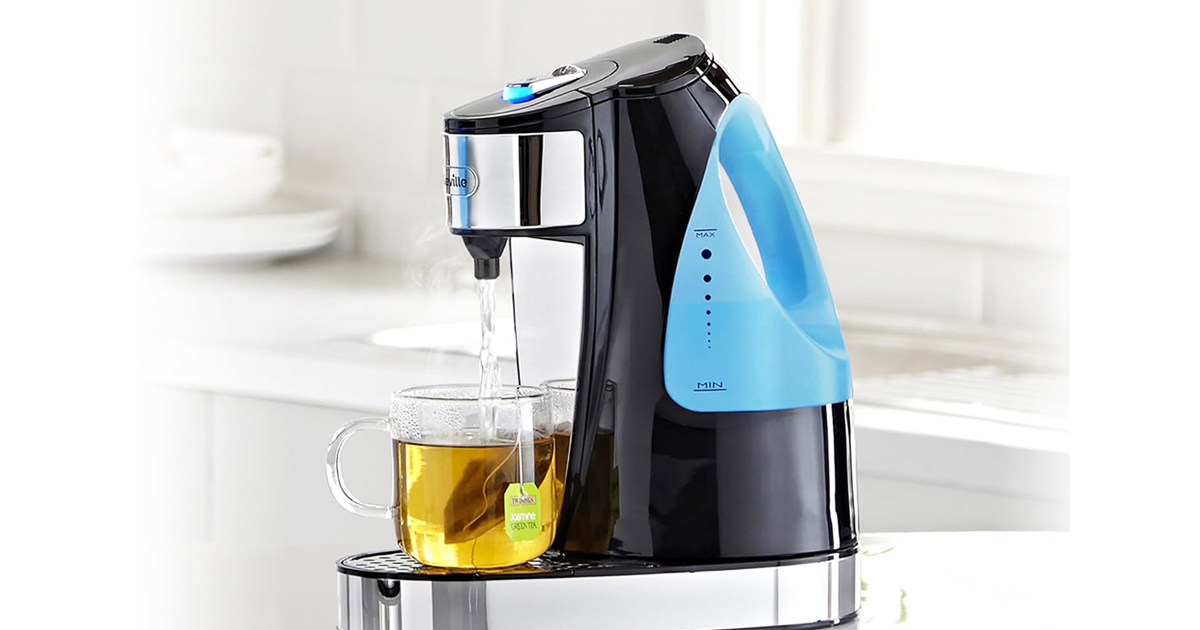 Breville HotCup hot water dispenser pouring boiling water into a glass mug of tea on a modern kitchen counter.