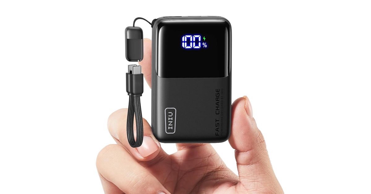 Ultra-compact INIU portable power bank with digital display and detachable USB-C cable, held between fingers to highlight its tiny size and travel-friendly design