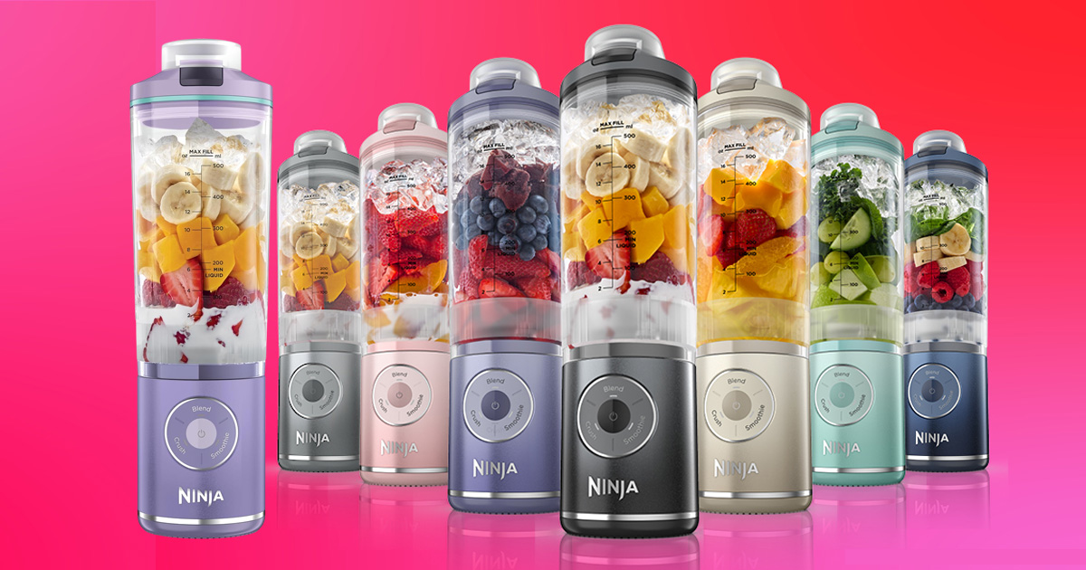 Colorful Ninja Twist portable smoothie blenders filled with fresh fruit, yogurt, and vegetables, showcasing multiple stylish colors for making healthy smoothies and protein shakes on the go.