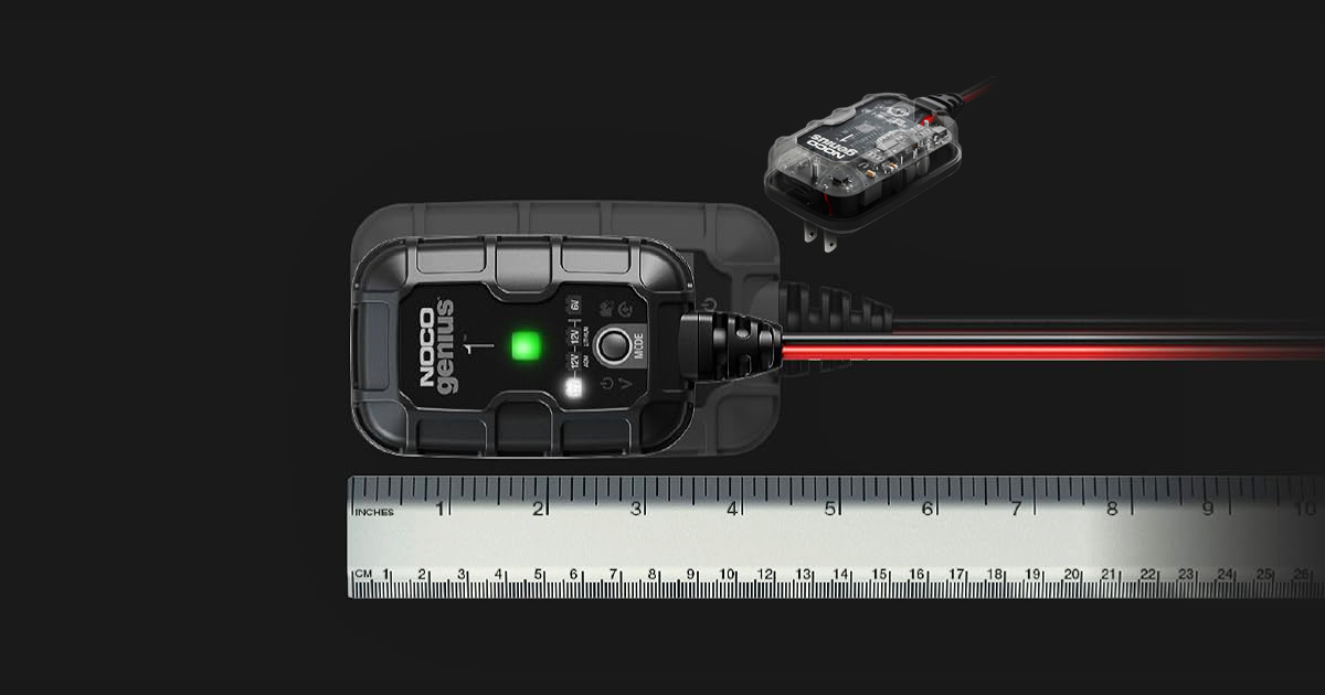NOCO GENIUS1 smart car battery charger shown with its charging cable, power adapter, indicator lights, and a ruler illustrating its compact size.