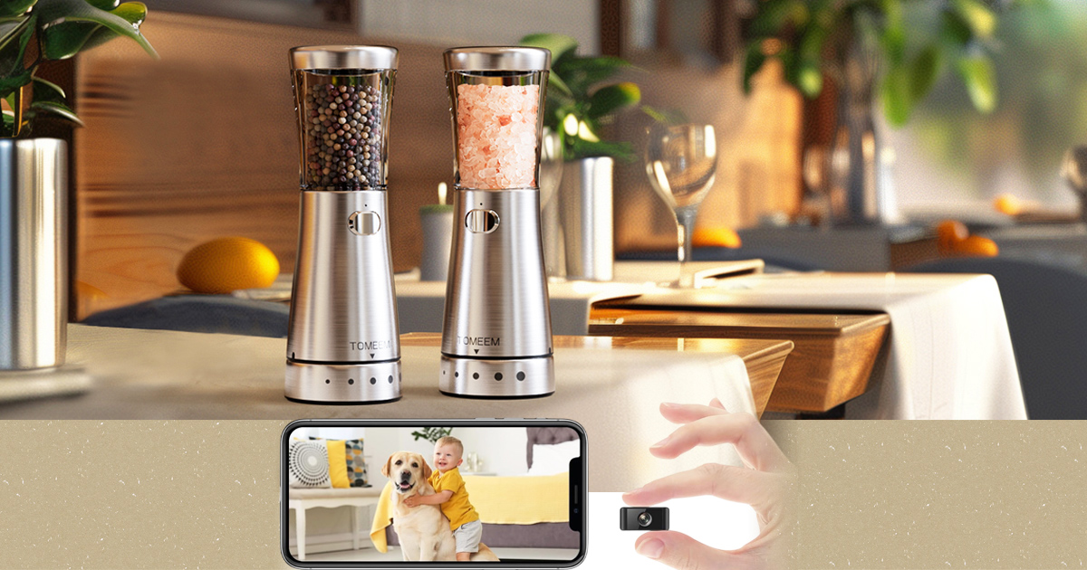 A lifestyle gadget showcase featuring a pair of electric stainless steel salt and pepper grinders on a dining table, and a mini security camera being held next to a smartphone displaying a live home monitor feed.